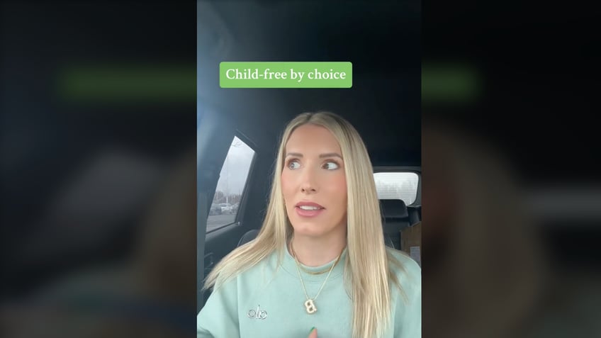 Woman talking at camera in TikTok video.