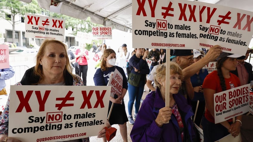 Protesters opposing trans athletes