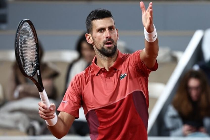 Champion on court: Novak Djokovic in action against Pierre-Hugues Herbert on Tuesday