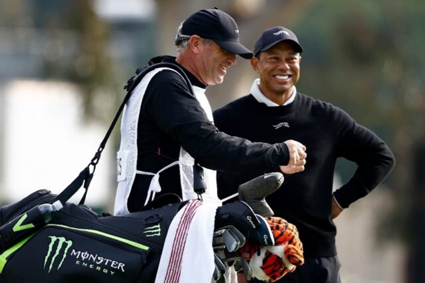 Golf superstar Tiger Woods enjoys a laugh with his caddie Lance Bennett during the pre-tou