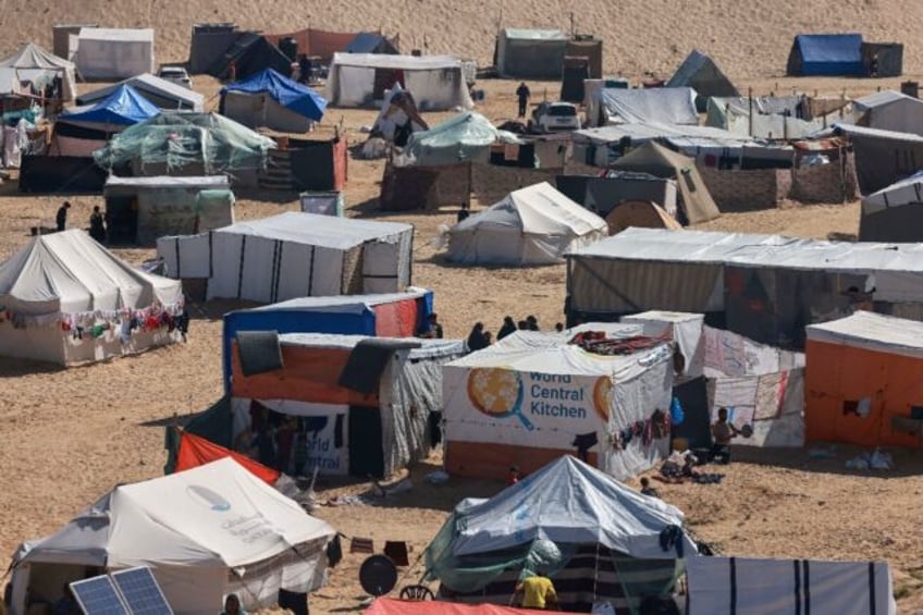 Palestinians' makeshift tents and a tent with the logo of World Central Kitchen in Rafah i