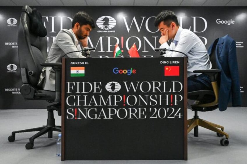 China's chess grandmaster Ding Liren (R, pictured at the start of the championship) and In