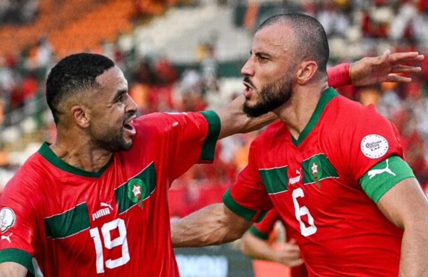 Romain Saiss (R) celebrates scoring for Morocco with Youssef En-Nesyri