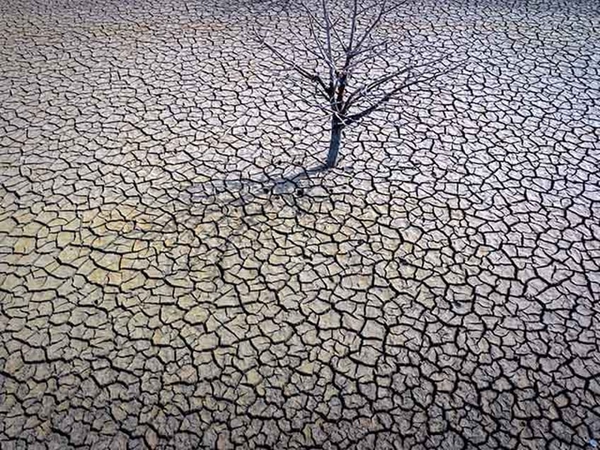 The cracked earth of the Sau reservoir is visible north of Barcelona, Spain, March 20, 2023. Earth last year shattered global annual heat records, the European climate agency said Tuesday, Jan. 9, 2024. (AP Photo/Emilio Morenatti, File)