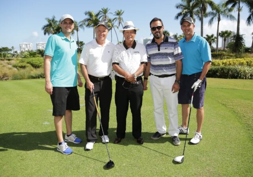 Chi Chi Rodriguez (centre) poses with guests at celebrity chef tournamentin Florida in 201