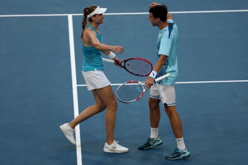 Kazakhstan's Elena Rybakina (L) and teammate Alexander Shevchenko celebrate their win at t