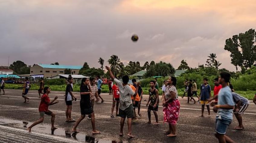 Tuvalu natives play sports at the airport.