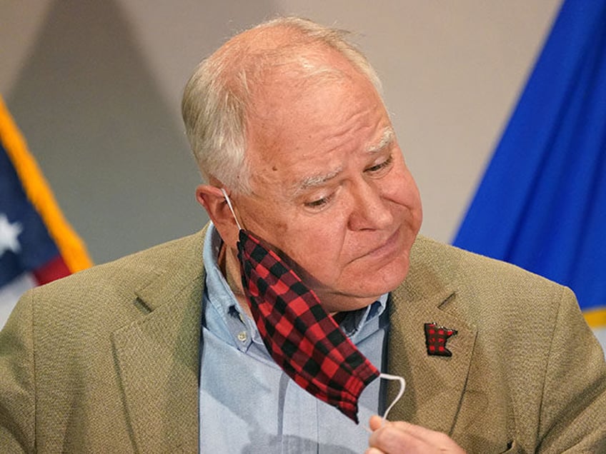 Gov. Tim Walz removed his buffalo plaid cloth mask as he took the podium to announce a sta