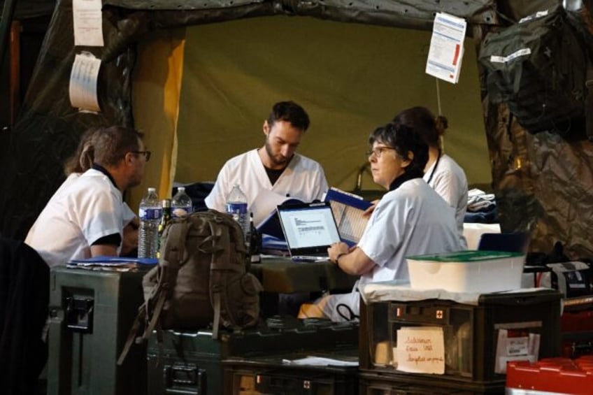 Military medical staff work aboard the French warship