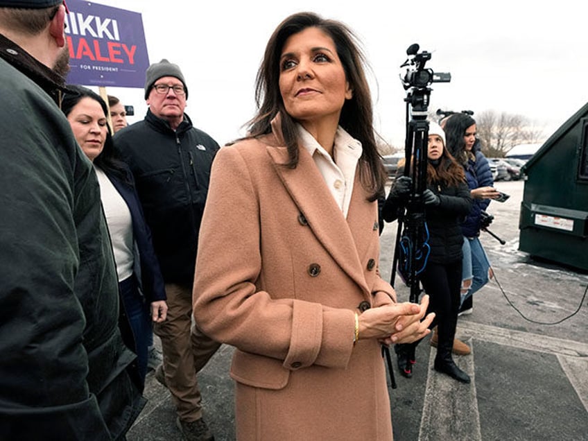 Republican presidential candidate former U.N. Ambassador Nikki Haley walks past members of the media while greeting people, Tuesday, Jan. 23, 2024, near a polling place at Winnacunnet High School in Hampton, N.H. (AP Photo/Steven Senne)