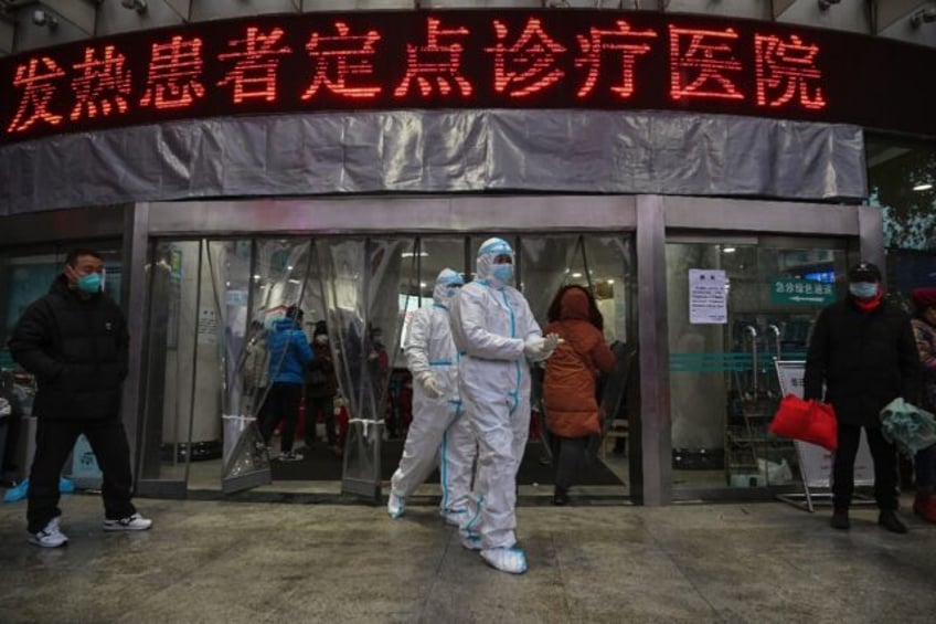 Medical staff members wear protective clothing outside the Wuhan Red Cross Hospital on Jan