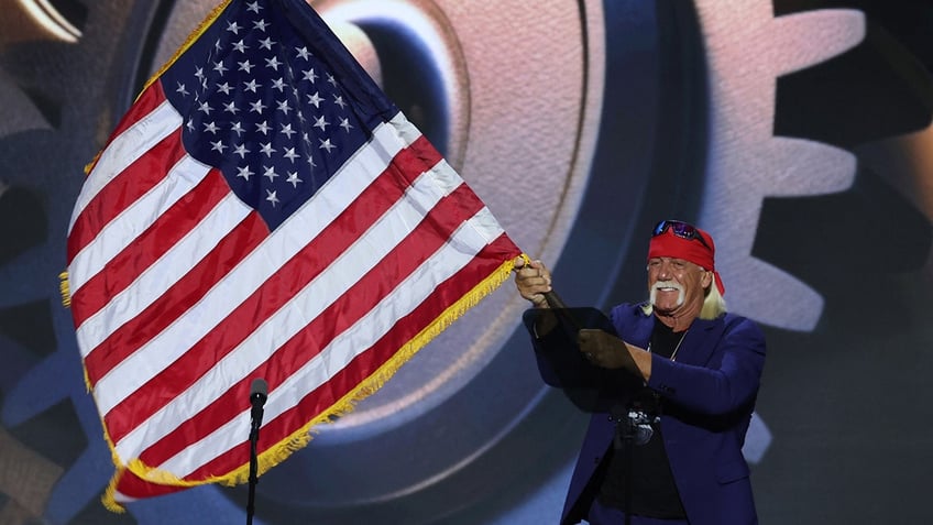 Hulk Hogan waves a U.S. flag as he takes the stage on Day 4 of the Republican National Convention