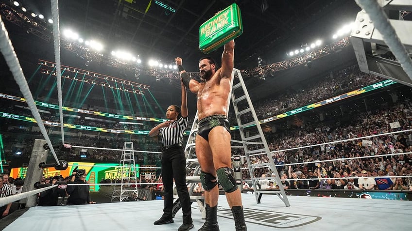 Drew McIntyre holds the briefcase