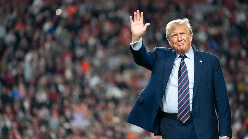 Former President Donald Trump waving to rally crowd