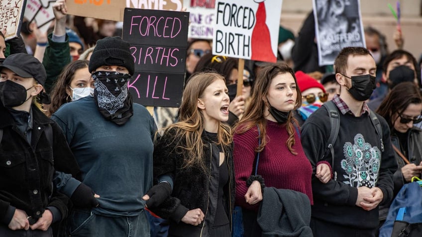 Counterprotesters try to block the National Men's March to abolish abortion and rally for personhood in Boston on Nov. 16, 2024.