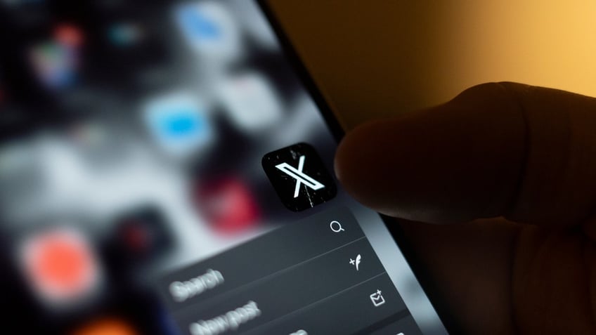 X logo on phone screen