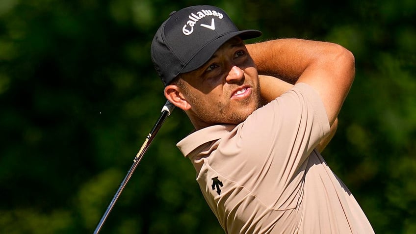 Xander Schauffele looks on