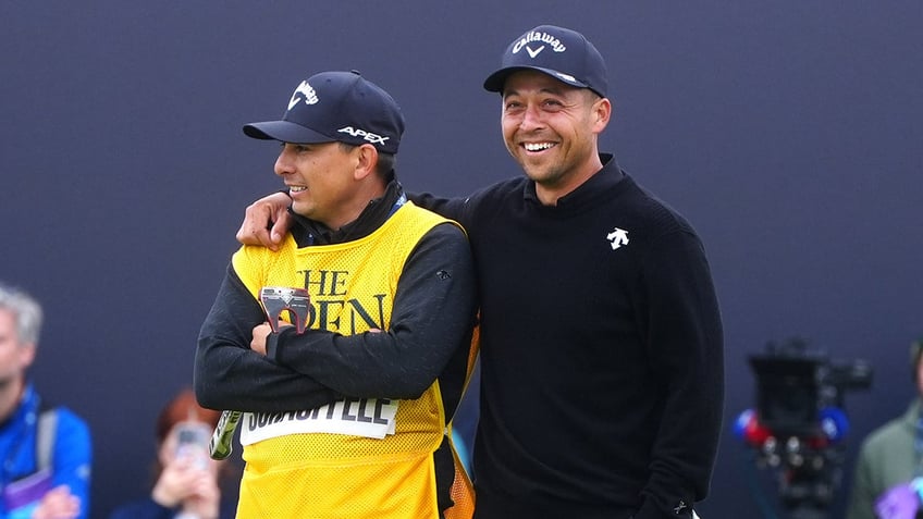 Xander Schauffele celebrates with caddie