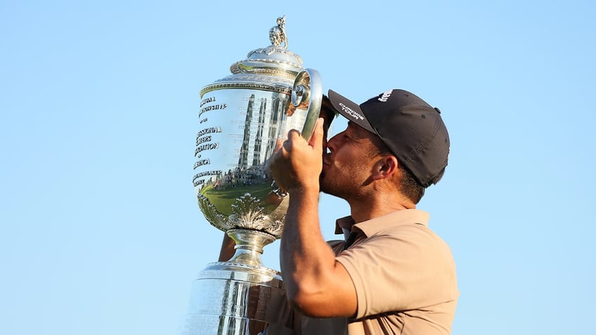 Xander kissing trophy