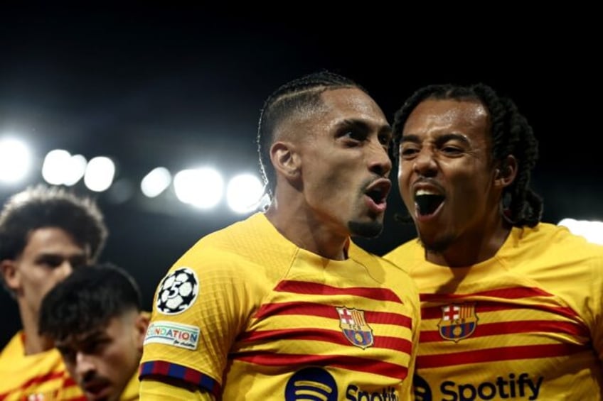 Raphinha (C) celebrates after scoring one of his two goals in Barcelona's 3-2 win over PSG