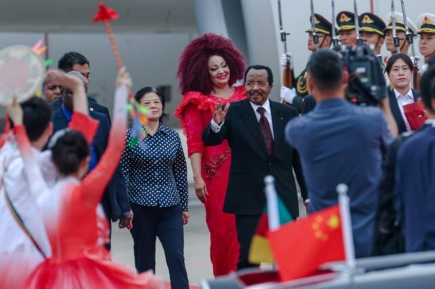 Cameroon's President Paul Biya (C) waves as he arrives at Beijing Capital International Ai