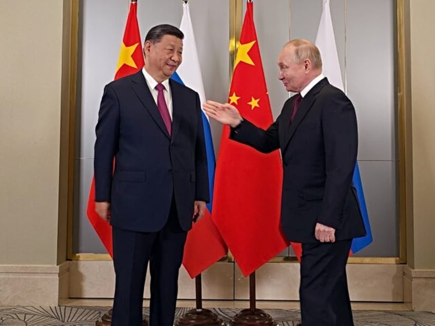 ASTANA, KAZAKHSTAN - JULY 3 (RUSSIA OUT) Russian President Vladimir Putin (R) greets Chine