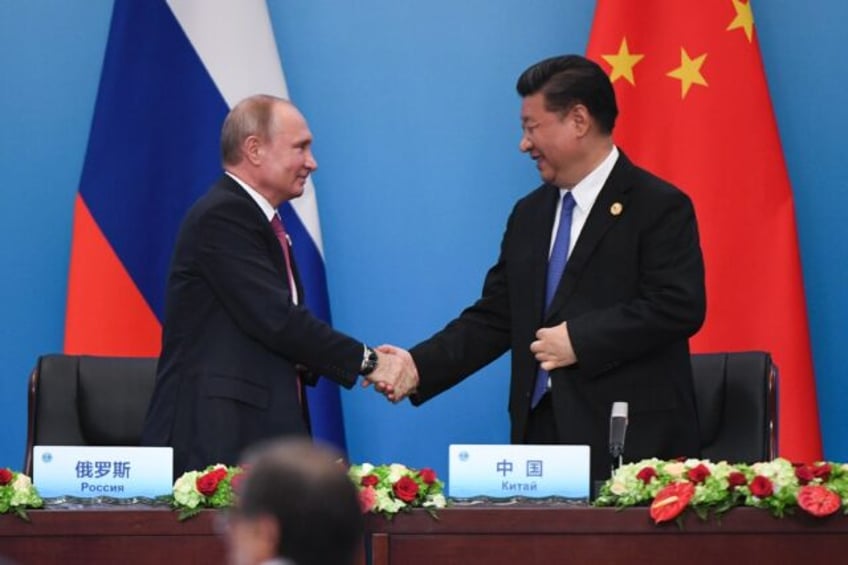 xi putin to freshen decade long friendship at beijing summit