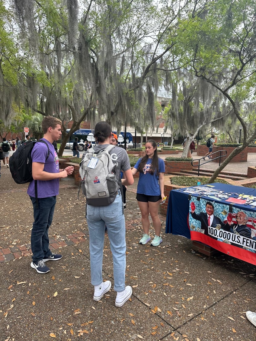 yaf students use schweizers blood money to warn students about the ccps subversion of america