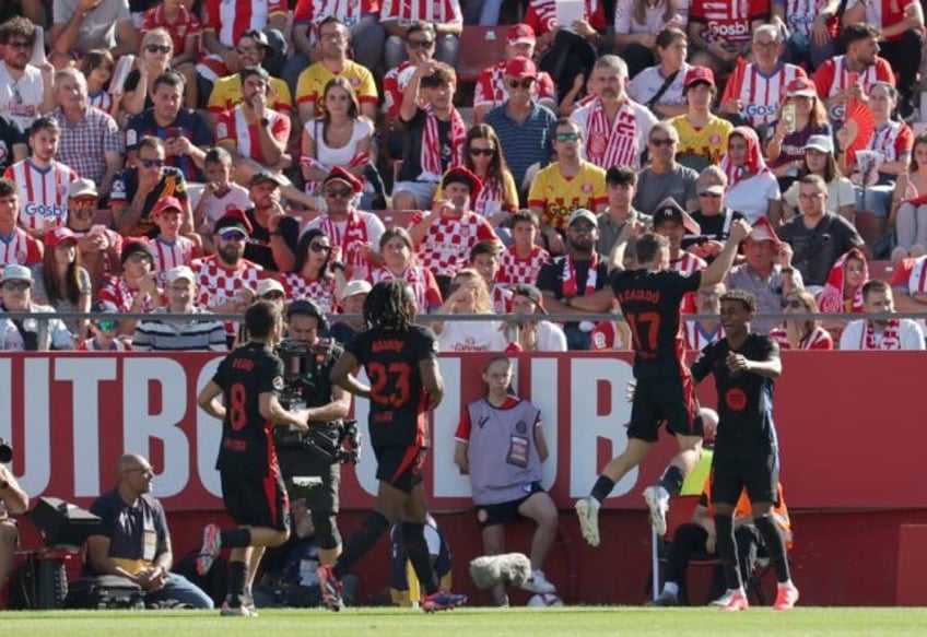 Barcelona's starlet Lamine Yamal (R) celebrates scoring his team's second goal against Gir