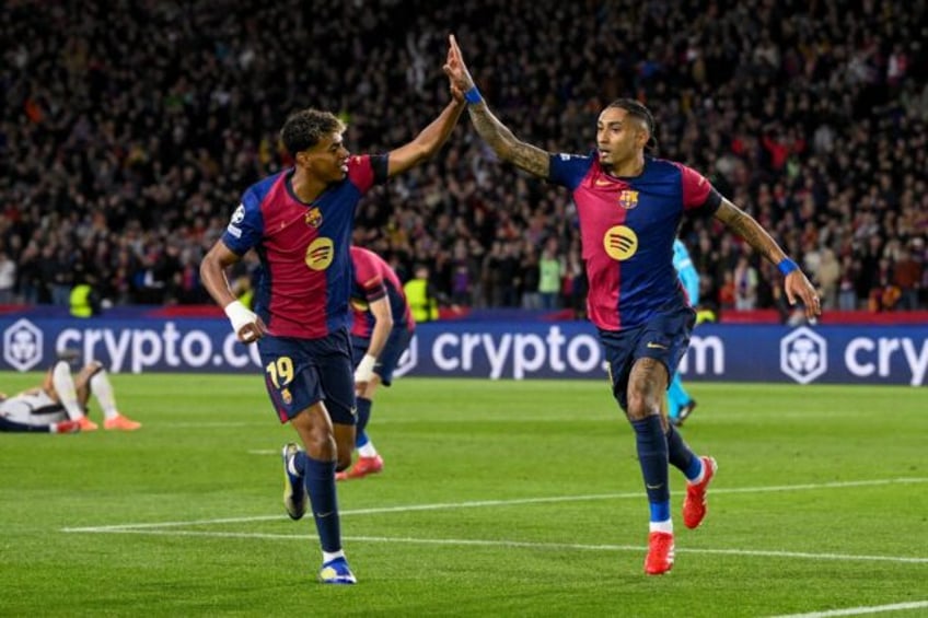 Barcelona's Brazilian forward Raphinha (R) celebrates with Lamine Yamal after scoring his