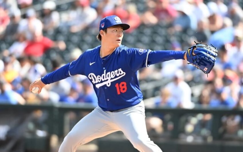 Yoshinobu Yamamoto of the Los Angeles Dodgers delivers a second-inning pitch against the T