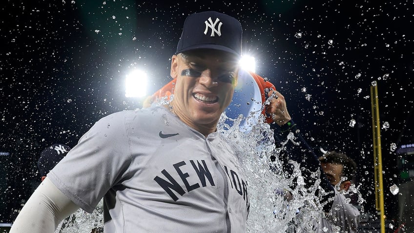 Aaron Judge smiles after being dunked with water