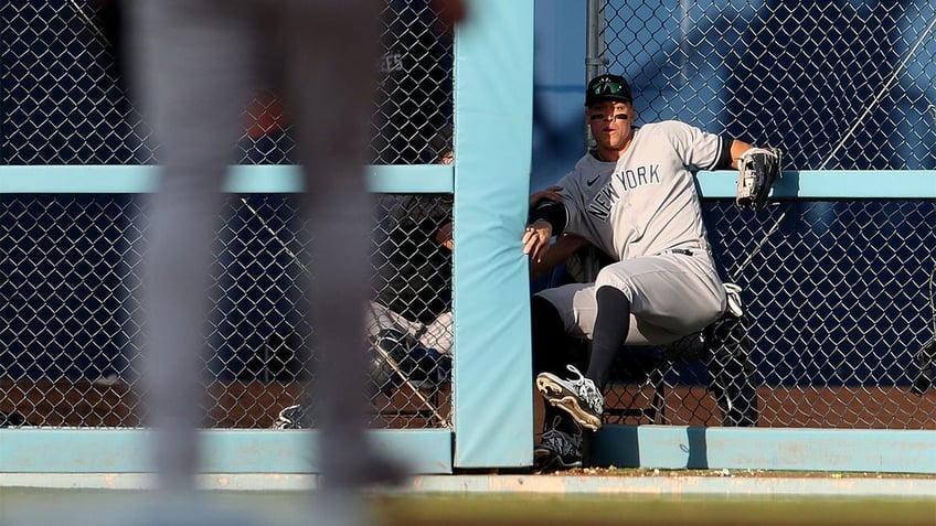 Aaron Judge crashes through fence