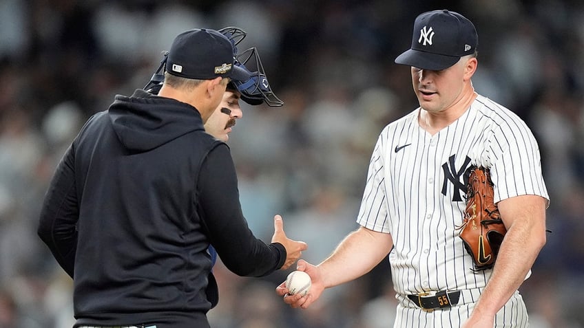 Carlos Rodon hands the ball to Aaron Boone