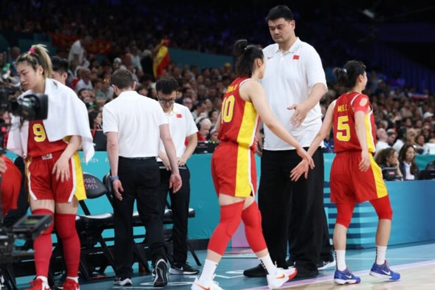 Yao Ming attends a women's basketball match at the Paris Olympics