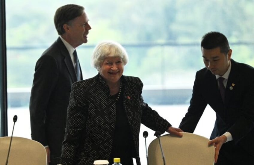 US Treasury chief Janet Yellen (C) and Ambassador to China Nicholas Burns (L) attend a rou