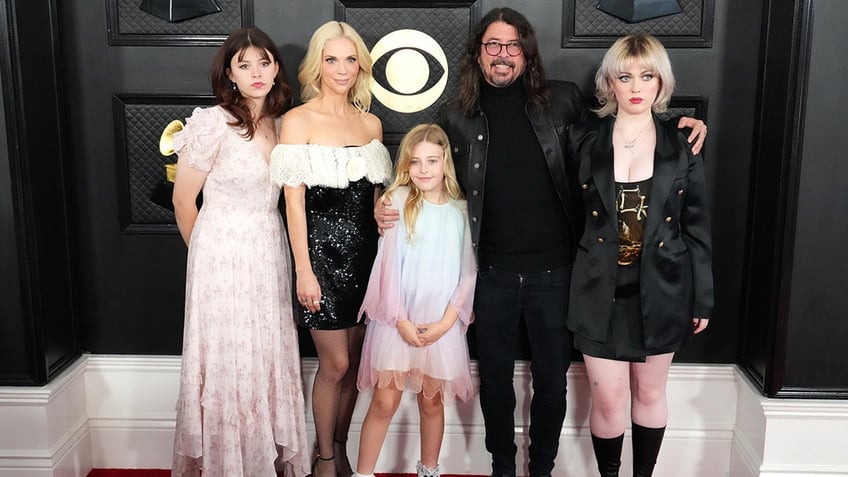 Foo Fighters star Dave Grohl hugs his daughters at Grammys