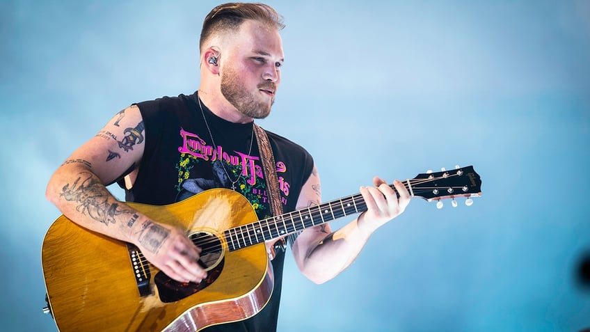 Zach Bryan performing during his tour