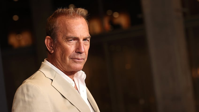 Semi profile angle of Kevin Costner in a white suit