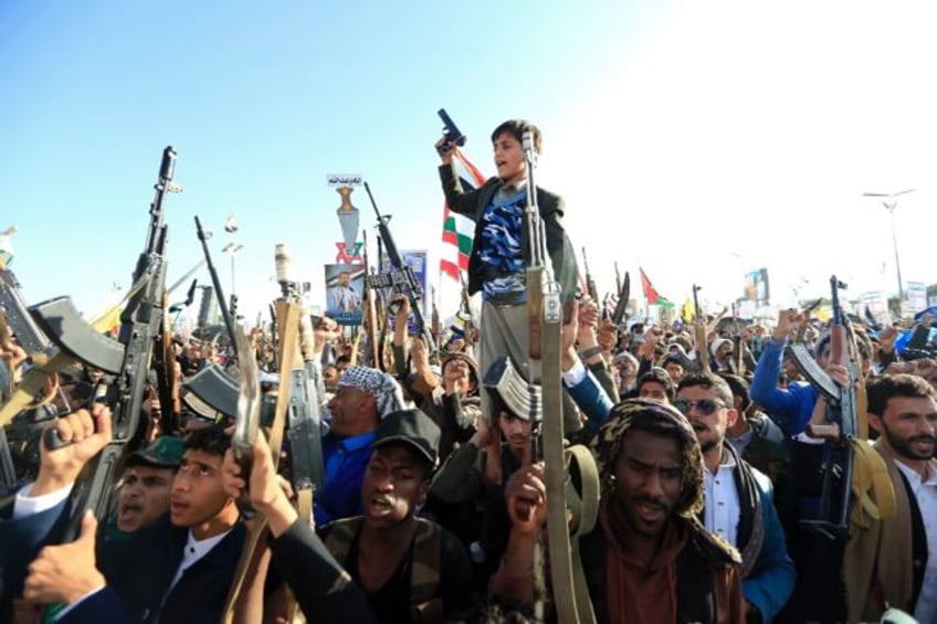 Yemenis brandish rifles and chant slogans during regular anti-Israel demonstrations in San