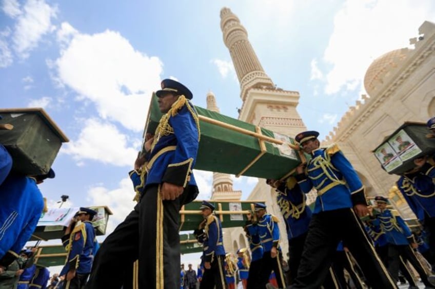 Mourners gathered outside a Sanaa mosque as Huthi fighters staged a parade honouring those
