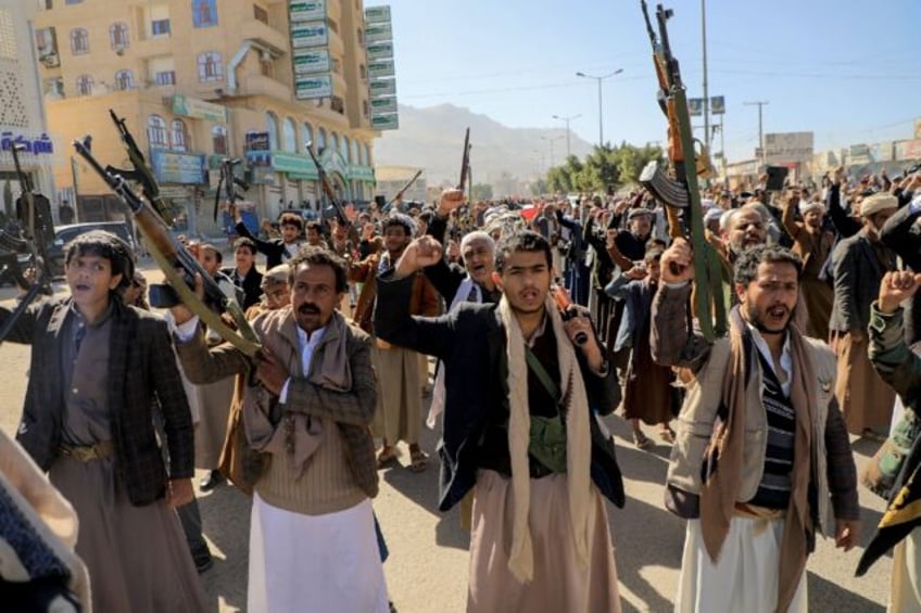 Armed demonstrators take part in a solidarity rally with Gaza in the rebel-held Yemeni capital Sanaa