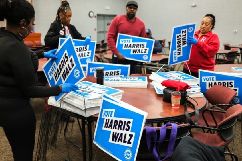 Members of the United Auto Workers (UAW) prepare campaign signs