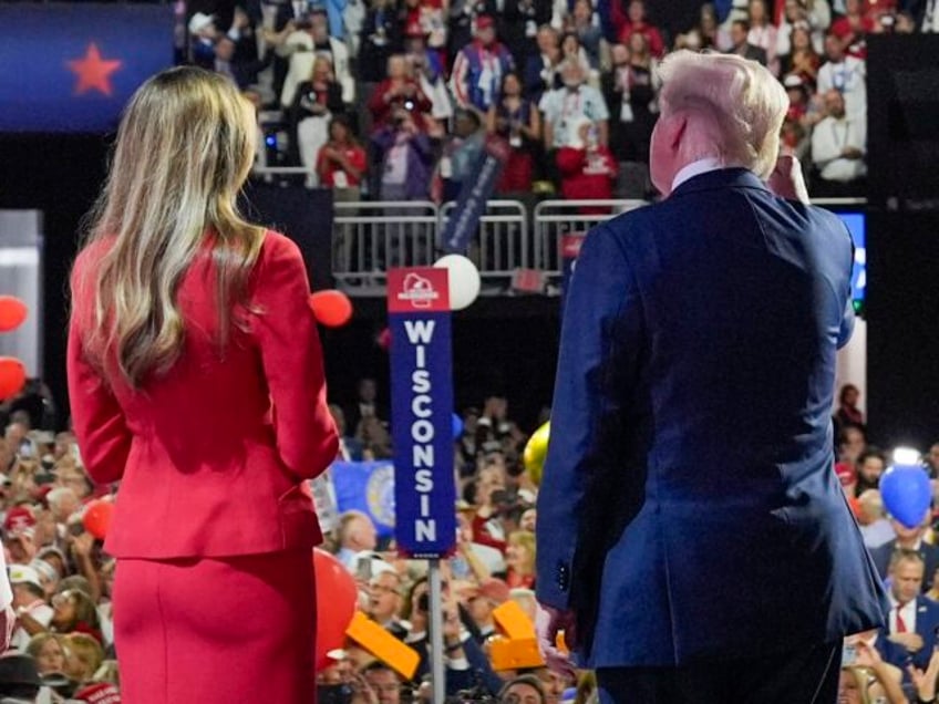 Republican presidential candidate former President Donald Trump stands on stage with forme