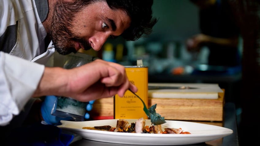 A chef plating food