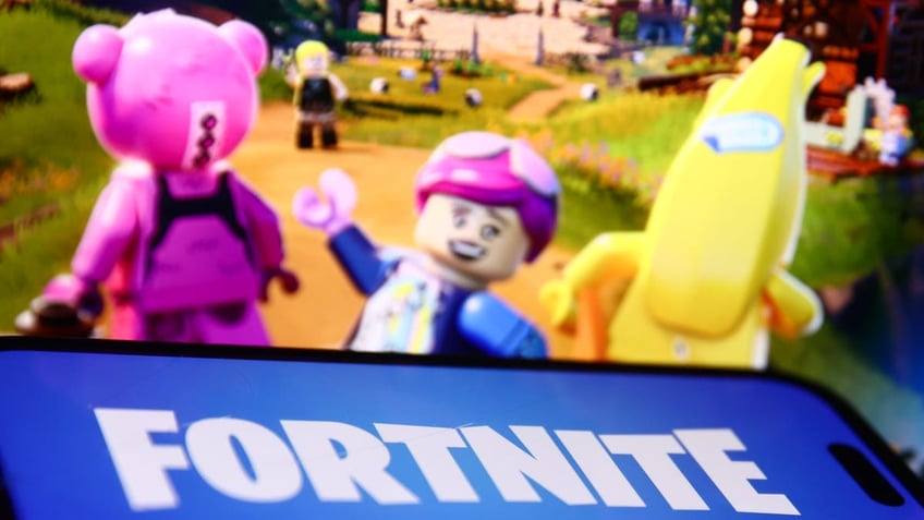 Lego Fortnite website displayed behind video game logo