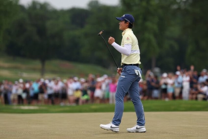 Japan's Yuka Saso celebrates after holing a putt at the 72nd hole on the way to victory in