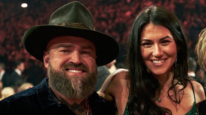 Zac Brown sports black hat with Kelly Yazdi