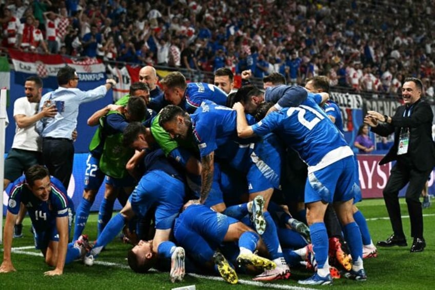 Mattia Zaccagni was bundled by his Italy teammates after firing the Azzurri into the last