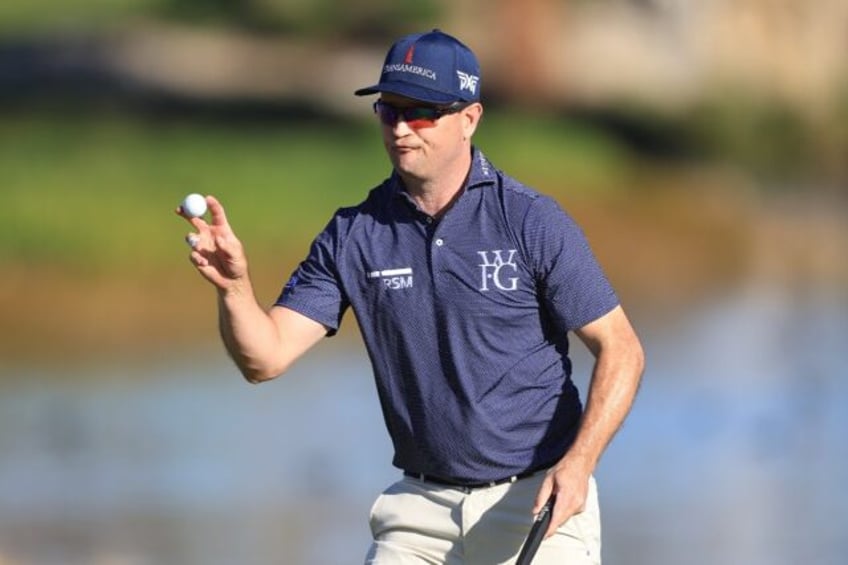 American Zach Johnson acknowledges fans after grabbing a share of the first-round lead in the US PGA Tour American Express tournament in La Quinta, California